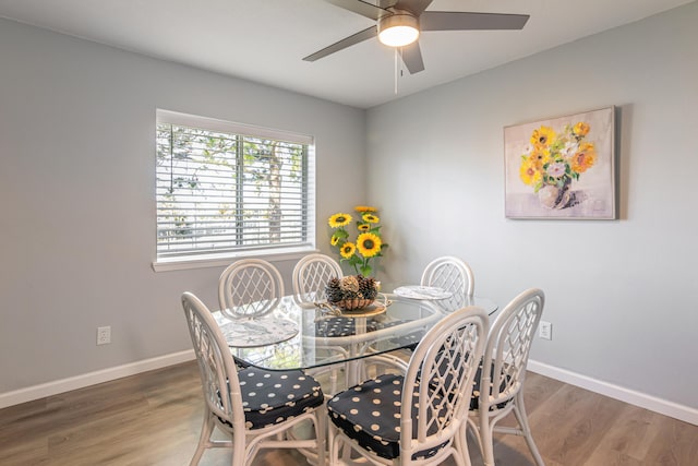 dining area with hardwood / wood-style flooring and ceiling fan