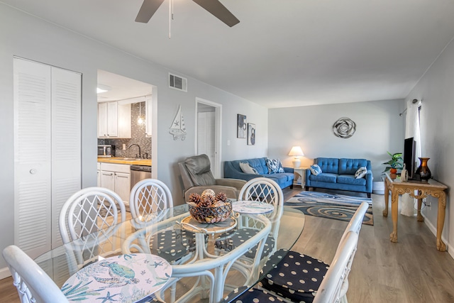 dining room featuring light hardwood / wood-style floors and ceiling fan