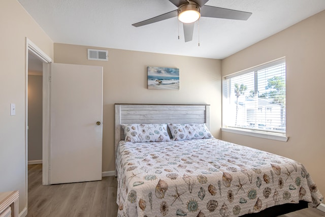 bedroom featuring ceiling fan and light hardwood / wood-style flooring