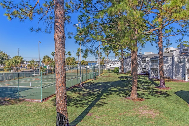 view of tennis court with a lawn