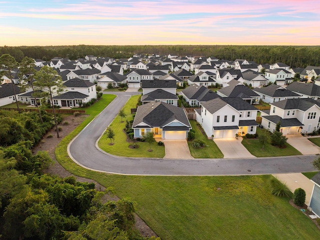 aerial view at dusk featuring a residential view