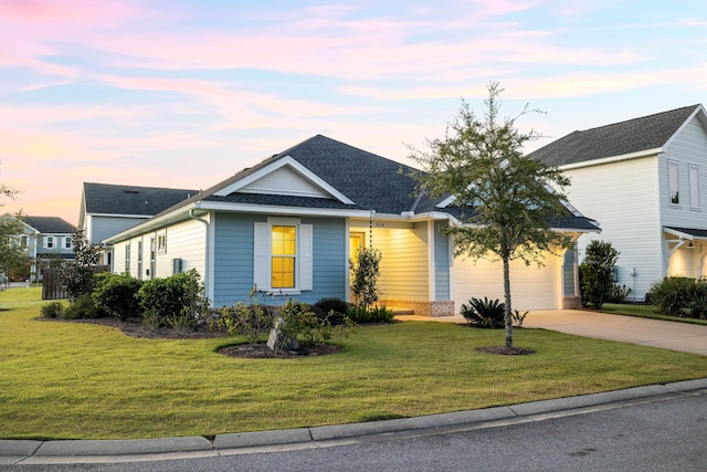 ranch-style house with a yard and a garage