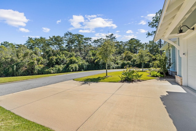 view of patio featuring a garage and driveway