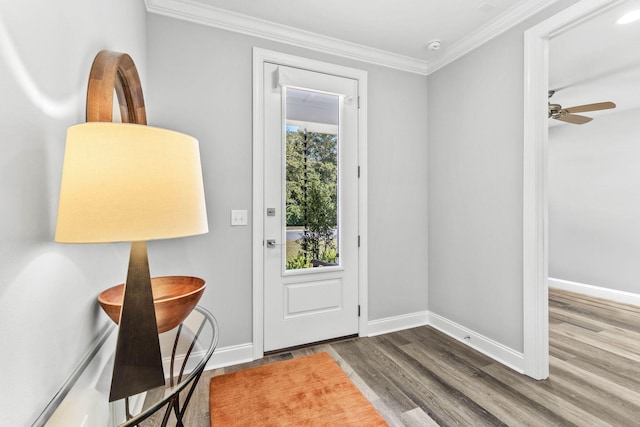 entrance foyer with wood finished floors, baseboards, and ornamental molding