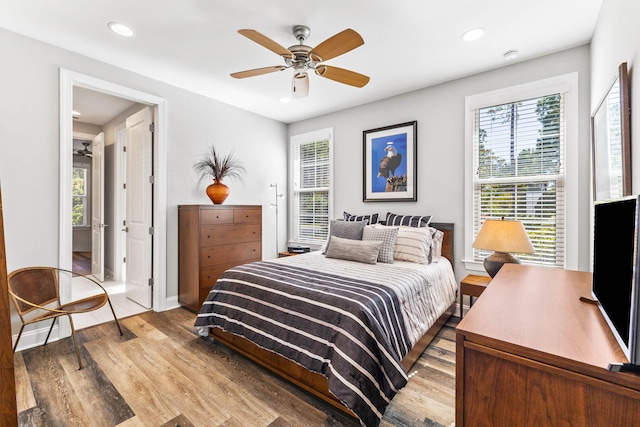 bedroom with baseboards, a ceiling fan, wood finished floors, and recessed lighting