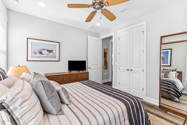 bedroom with visible vents, wood finished floors, recessed lighting, and a closet