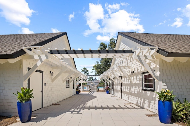 view of property's community with a pergola and a patio