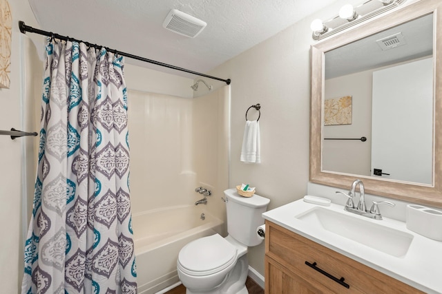 full bathroom featuring vanity, toilet, a textured ceiling, and shower / tub combo with curtain