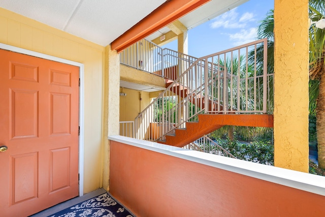 view of exterior entry with a balcony