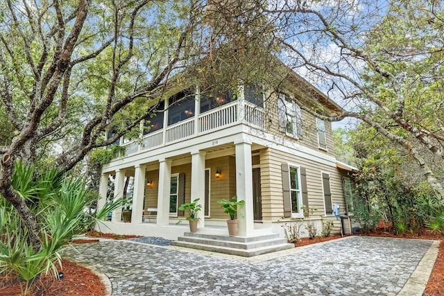 back of property featuring covered porch