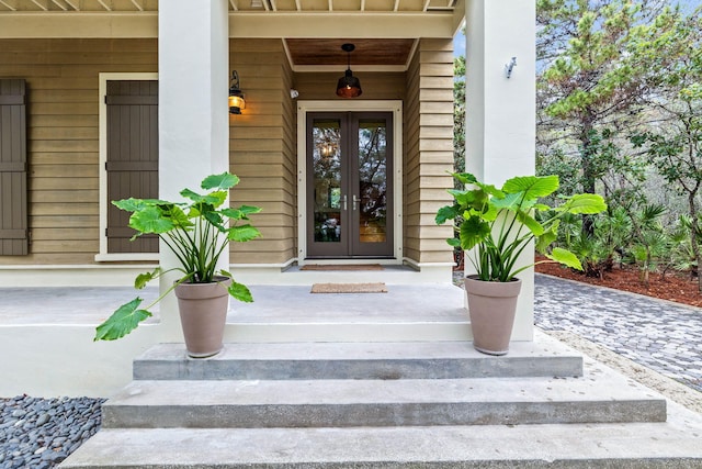 doorway to property featuring a porch and french doors