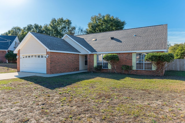 single story home with a garage and a front lawn