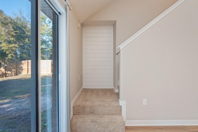 staircase featuring lofted ceiling