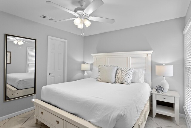 tiled bedroom with ceiling fan