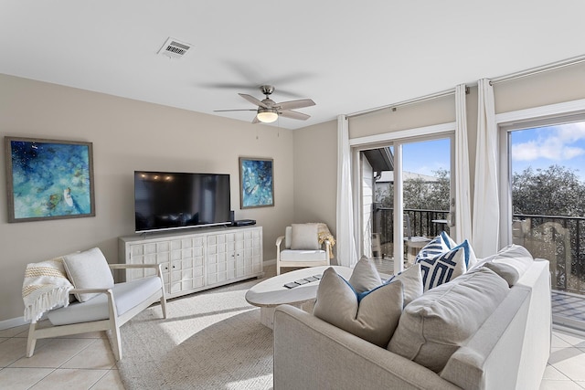 tiled living room featuring ceiling fan