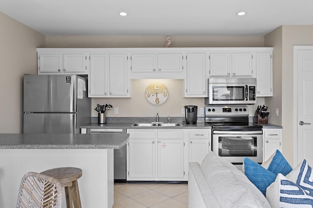 81 S Orange St Unit 209, Inlet Beach, FL 32461 - kitchen featuring appliances with stainless steel finishes, a sink, light tile patterned flooring, white cabinetry, and recessed lighting