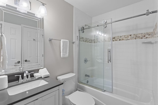 full bathroom with shower / bath combination with glass door, vanity, and toilet