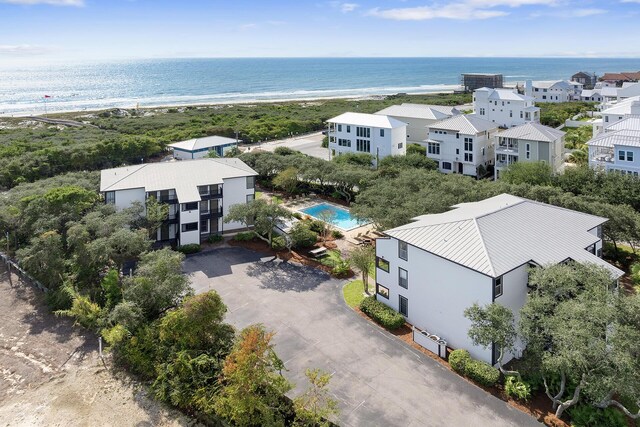 drone / aerial view with a beach view and a water view