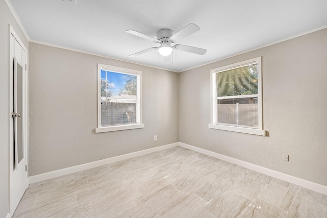 spare room with crown molding, a healthy amount of sunlight, and ceiling fan