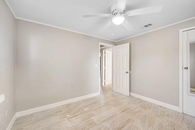 empty room with ornamental molding and ceiling fan