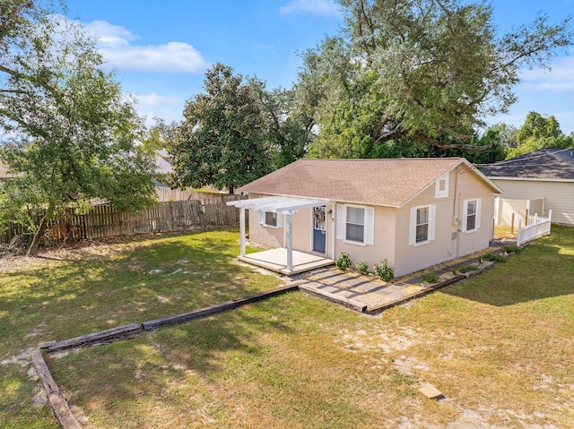 back of property with a patio and a yard