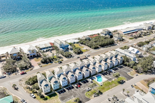 birds eye view of property with a water view and a view of the beach