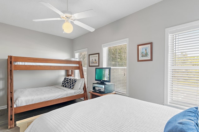 bedroom with ceiling fan and multiple windows