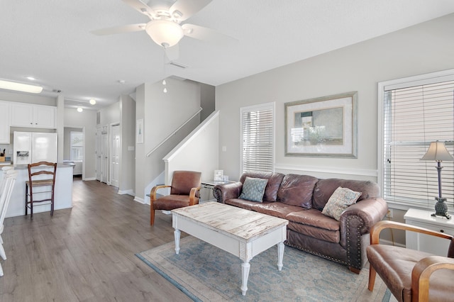 living room featuring ceiling fan and light wood-type flooring