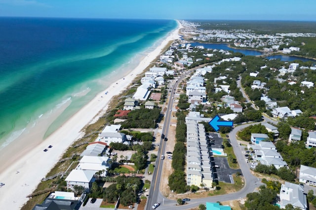 drone / aerial view featuring a water view and a view of the beach