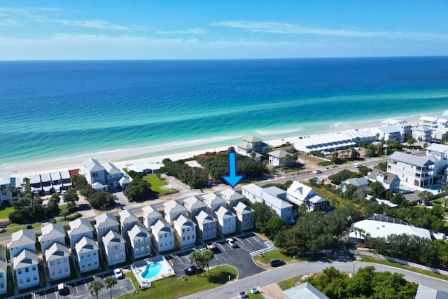 bird's eye view with a water view and a beach view