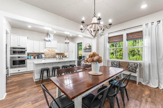 dining room featuring dark wood-type flooring and an inviting chandelier