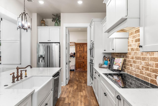 kitchen featuring dark wood-type flooring, light stone counters, stainless steel appliances, and white cabinets