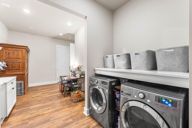 washroom featuring light hardwood / wood-style floors and washing machine and dryer