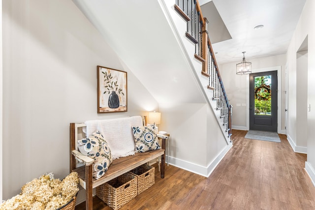 entrance foyer with a notable chandelier and hardwood / wood-style flooring