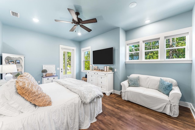 bedroom with dark hardwood / wood-style flooring and ceiling fan