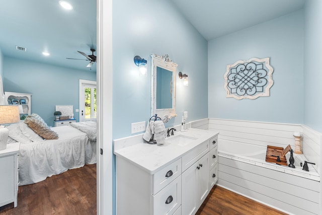 bathroom with vanity, a bathtub, wood-type flooring, and ceiling fan