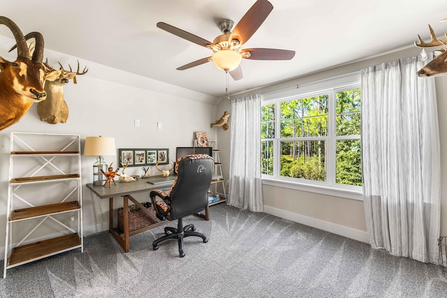 carpeted office space with ceiling fan