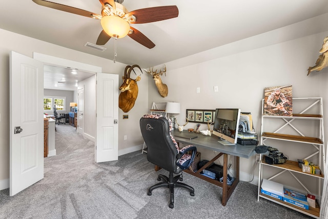 carpeted office featuring ceiling fan