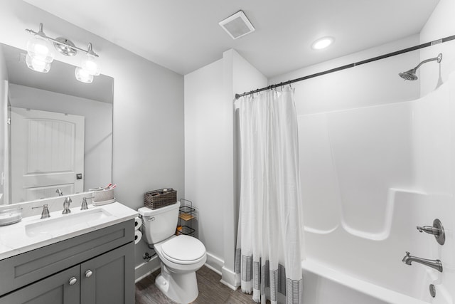 full bathroom with vanity, toilet, wood-type flooring, and shower / bath combo