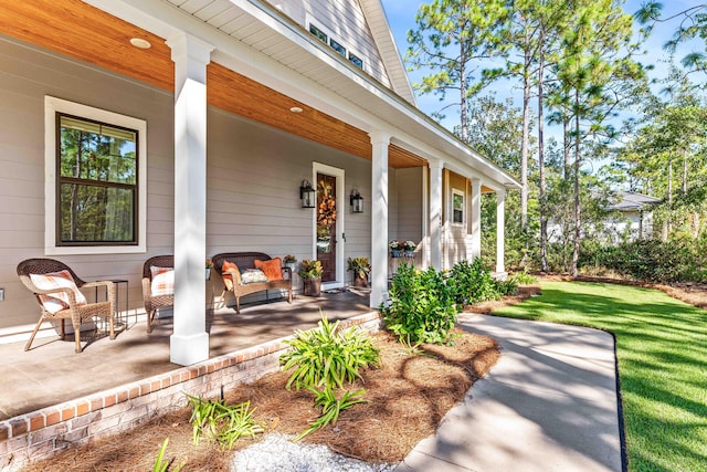 property entrance featuring a yard and covered porch