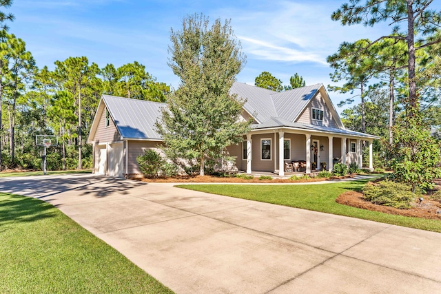 country-style home featuring a porch, a front lawn, and a garage