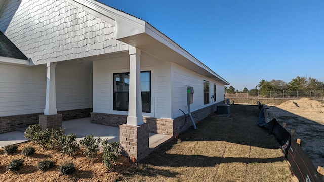 view of property exterior featuring cooling unit and a patio