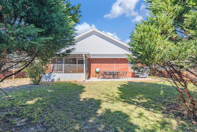 view of yard featuring a patio area and a sunroom