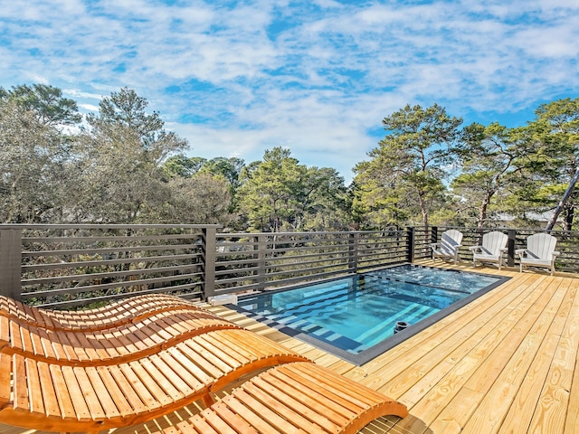 view of swimming pool with a wooden deck and a hot tub