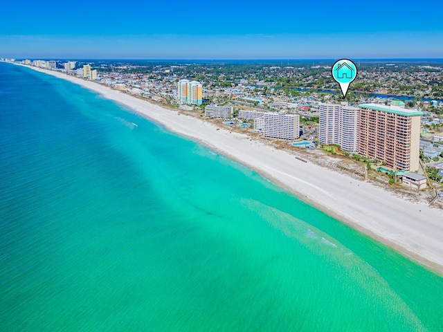 birds eye view of property with a water view and a beach view