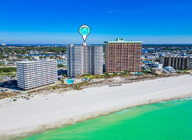 birds eye view of property featuring a water view and a beach view