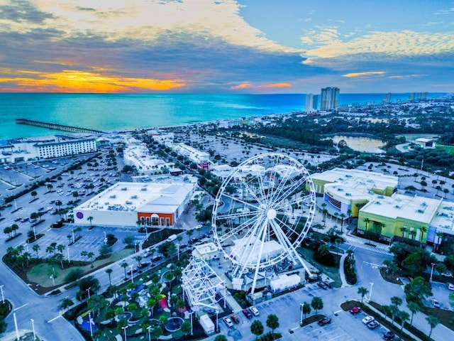 aerial view at dusk featuring a water view