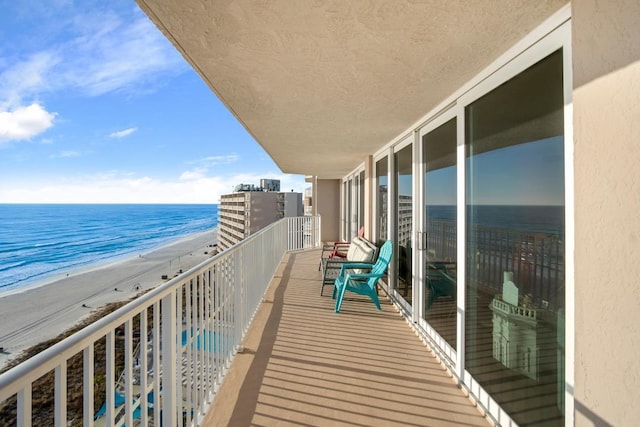 balcony with a beach view and a water view