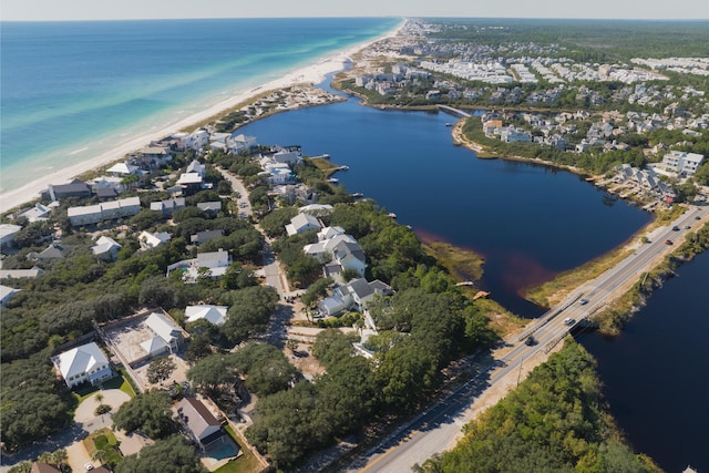 aerial view with a water view and a beach view