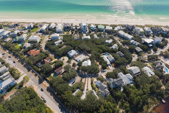 bird's eye view with a water view and a beach view